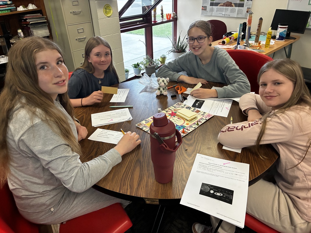 Students smile as they try out their review game that they created to prepare for end-of-year testing.