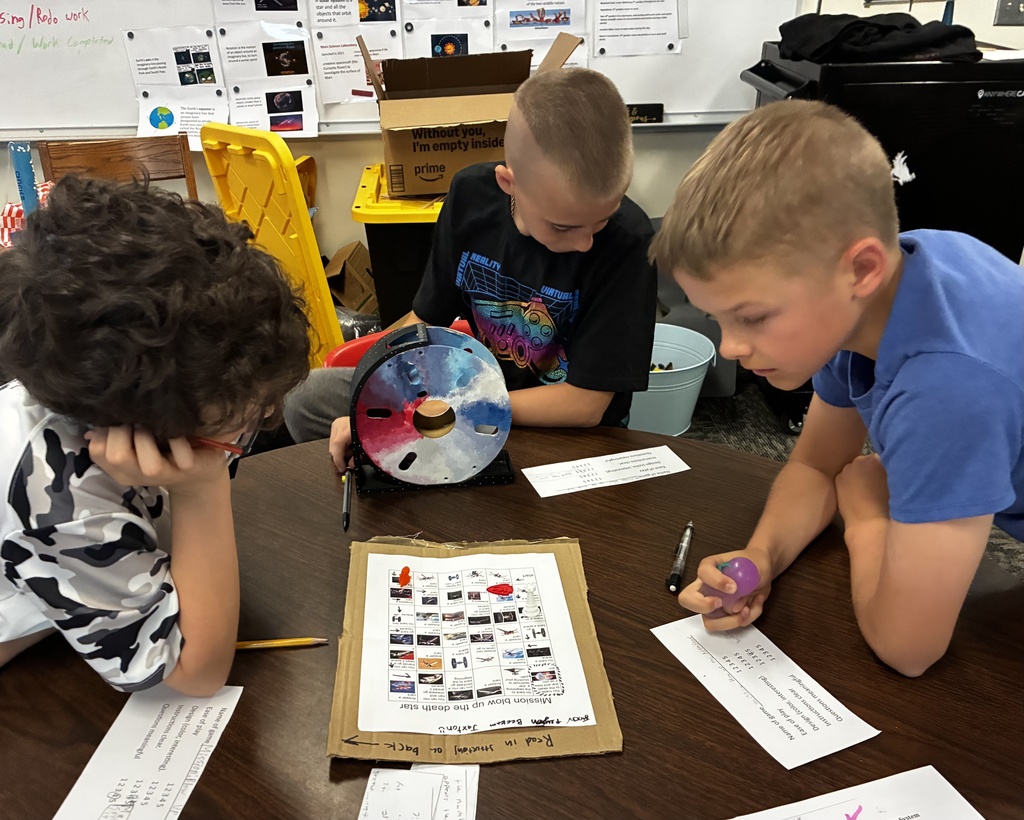 Students smile as they try out their review game that they created to prepare for end-of-year testing.