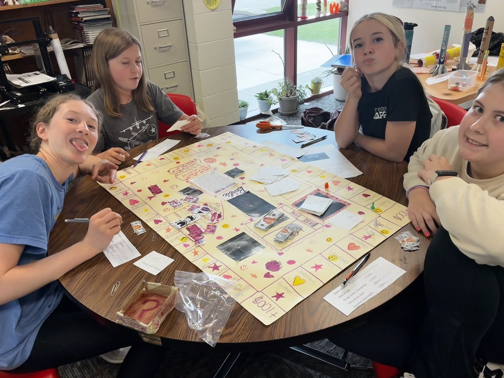 Students smile as they try out their review game that they created to prepare for end-of-year testing.