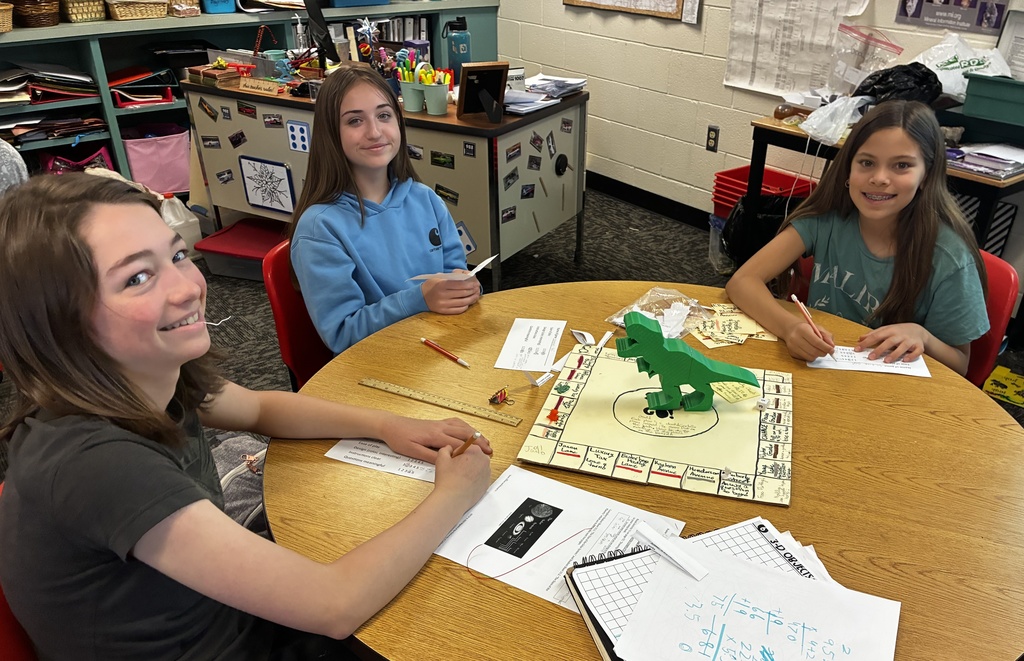 Students smile as they try out their review game that they created to prepare for end-of-year testing.