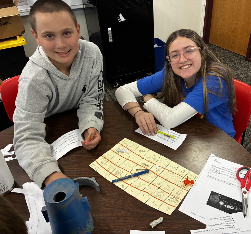 Students smile as they try out their review game that they created to prepare for end-of-year testing.