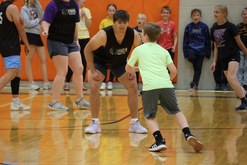 A high school student guards a Garfield student the Garfield vs. CCCHS Student Council basketball game.