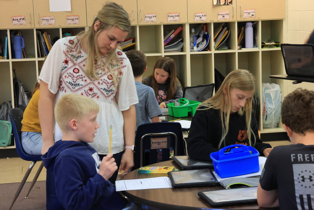 Ms. Bott checks over student work during their "My Pretend Life" simulation.