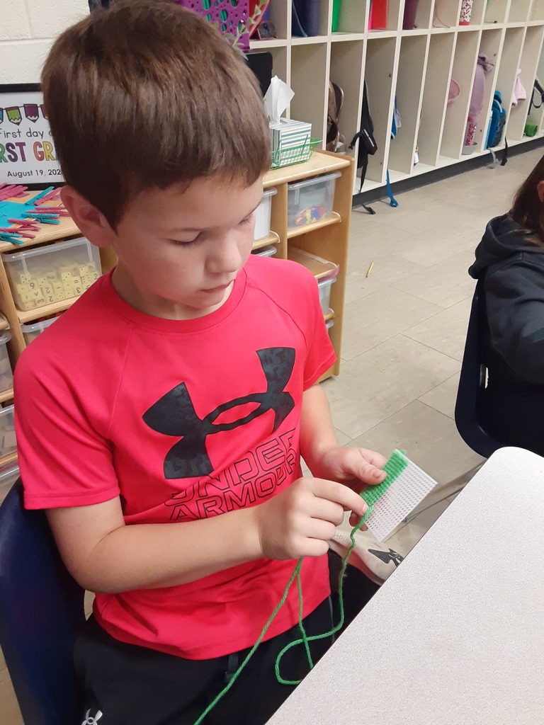 Members of Mrs. Carr's class work on their sewing canvas creations, which they have been working on as part of their soft start mornings.