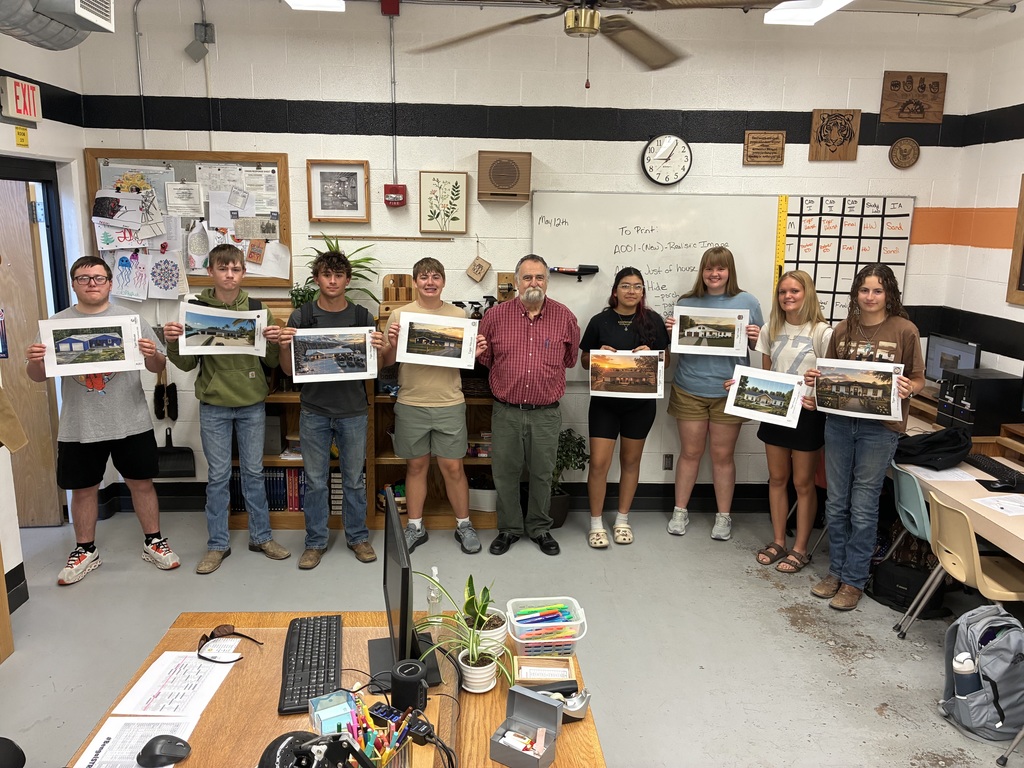 Students show their renderings that they  made of possible future Tiger House projects.