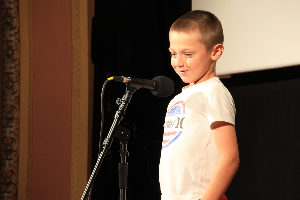 A student reads his poem during the "Popcorn and Poetry" event, which was held at the Rex Theatre.