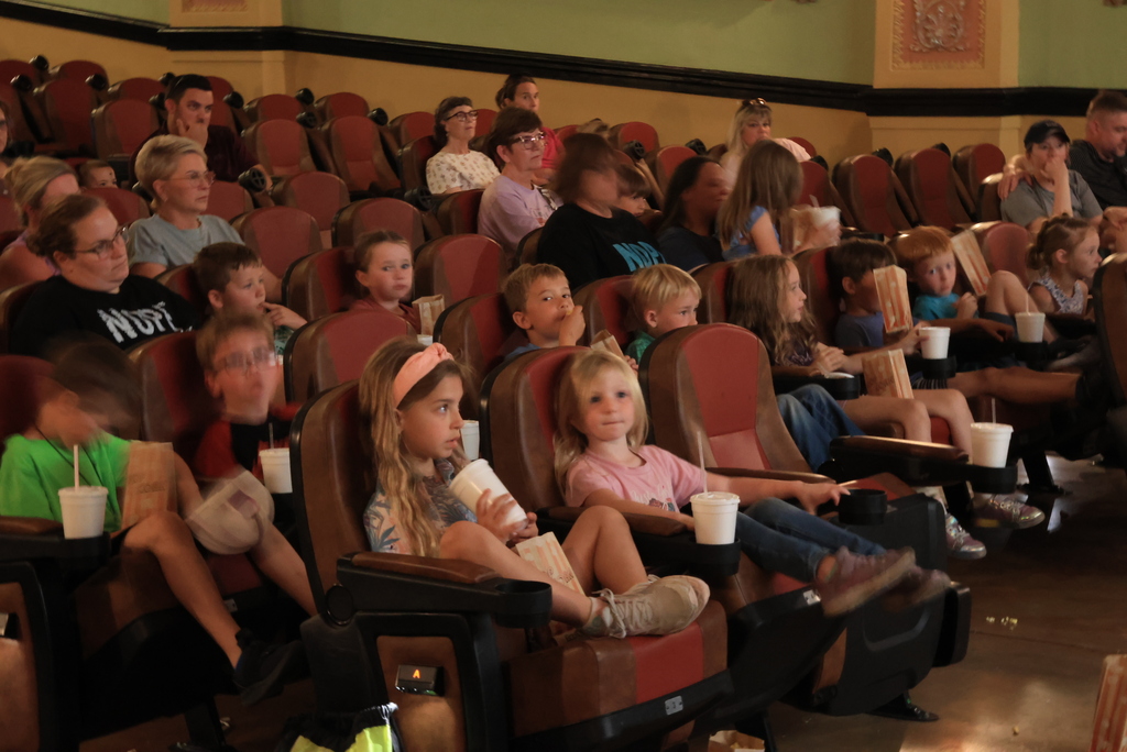 Students and family members listen to poetry during the "Popcorn and Poetry" event, which was held at the Rex Theatre.