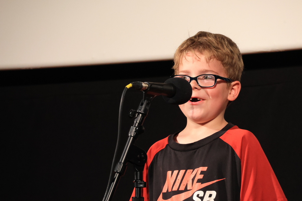 A student reads his poem during the "Popcorn and Poetry" event, which was held at the Rex Theatre.