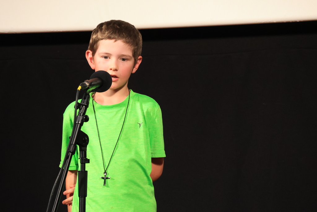A student reads his poem during the "Popcorn and Poetry" event, which was held at the Rex Theatre.
