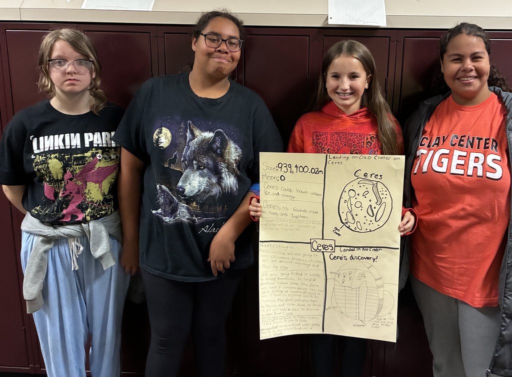 Mr. Walsh's 6th grade science students show off their space mission research project.