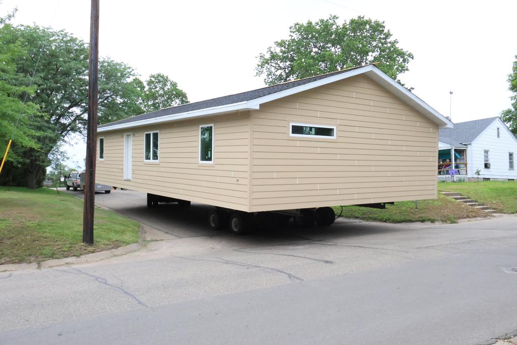 These are photos of the 2026 CCCHS Tiger House making its way through town and onto its permanent resting place at 725 Lane Street.