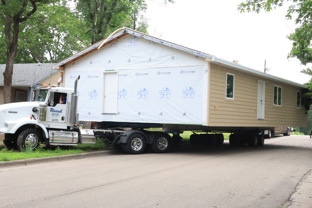 These are photos of the 2026 CCCHS Tiger House making its way through town and onto its permanent resting place at 725 Lane Street.