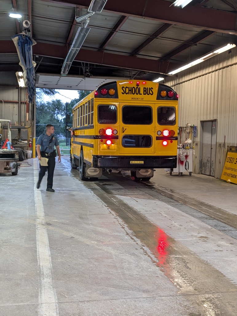Kansas Highway Patrol representatives look over USD 379 busses as part of their annual inspections.