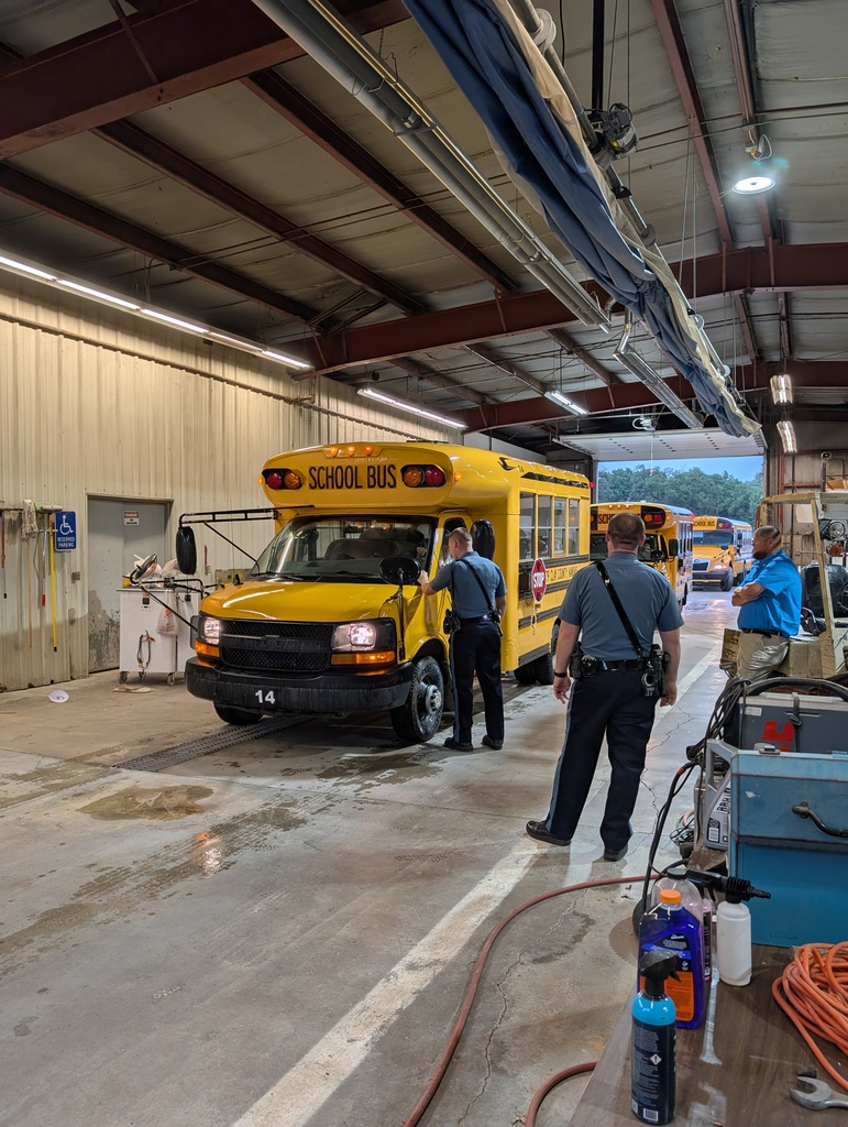 Kansas Highway Patrol representatives look over USD 379 busses as part of their annual inspections.