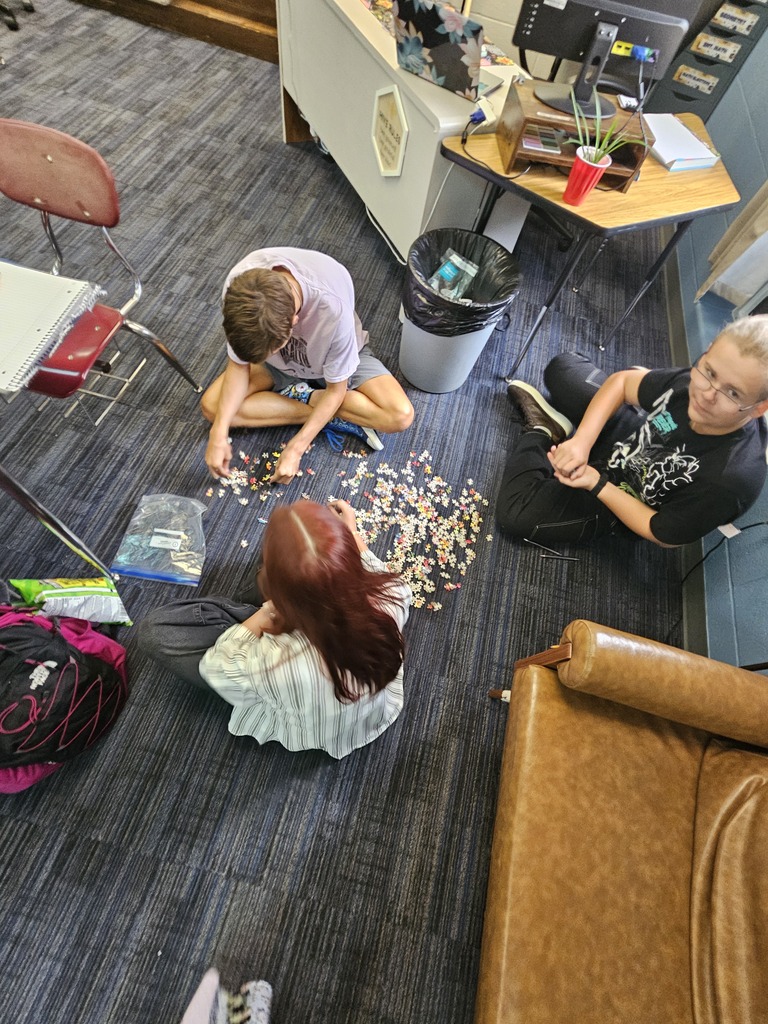 Students work together in small groups to solve a puzzle as part of a teamwork activity. The challenge encouraged students to recognize the importance of communication, having a shared goal, and collaborating to solve problems successfully.