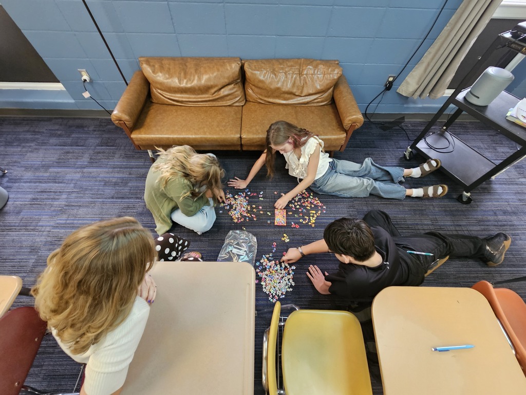 Students work together in small groups to solve a puzzle as part of a teamwork activity. The challenge encouraged students to recognize the importance of communication, having a shared goal, and collaborating to solve problems successfully.