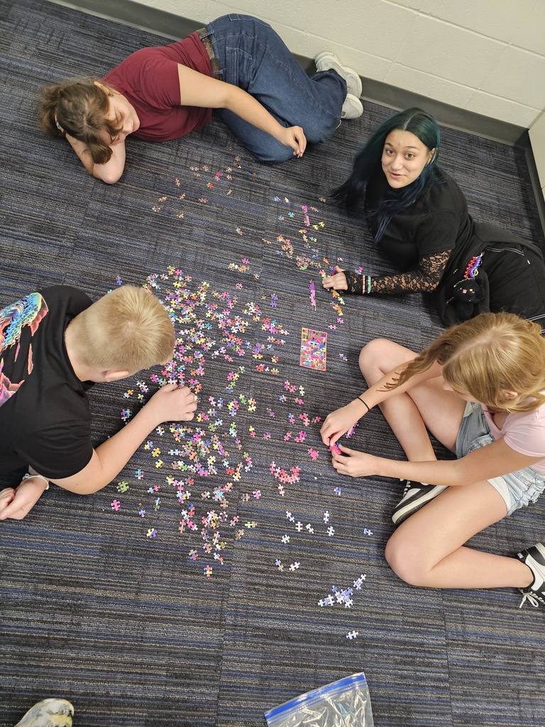 Students work together in small groups to solve a puzzle as part of a teamwork activity. The challenge encouraged students to recognize the importance of communication, having a shared goal, and collaborating to solve problems successfully.