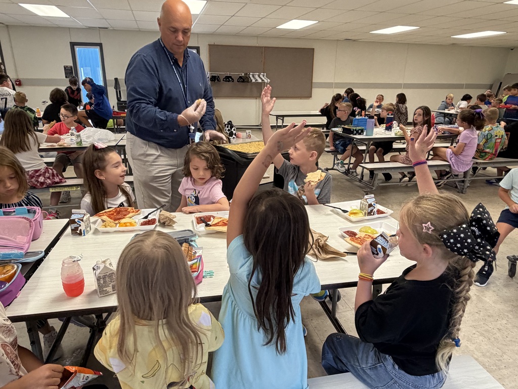 New principal Mr. Leis helps serve students food during lunch time.