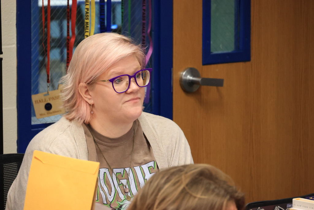 Mrs. Blackburn listens and grades student speeches.