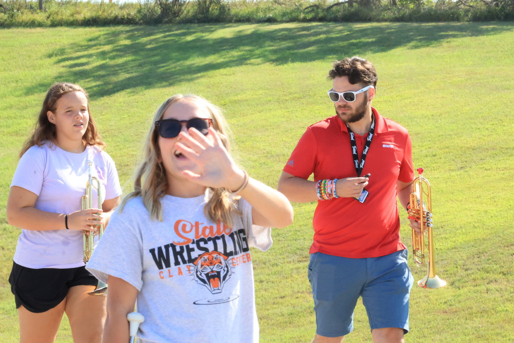 CCCMS 8th graders practice marching and twirling in the parking lot.