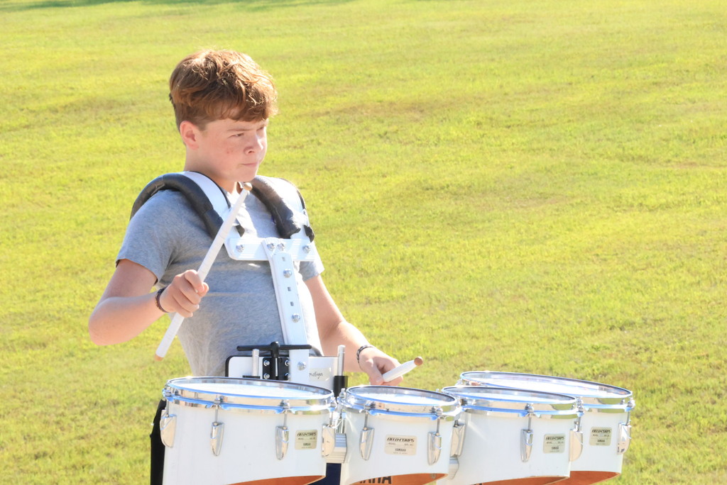 CCCMS 8th graders practice marching and twirling in the parking lot.