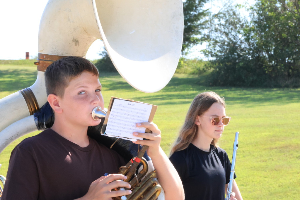 CCCMS 8th graders practice marching and twirling in the parking lot.