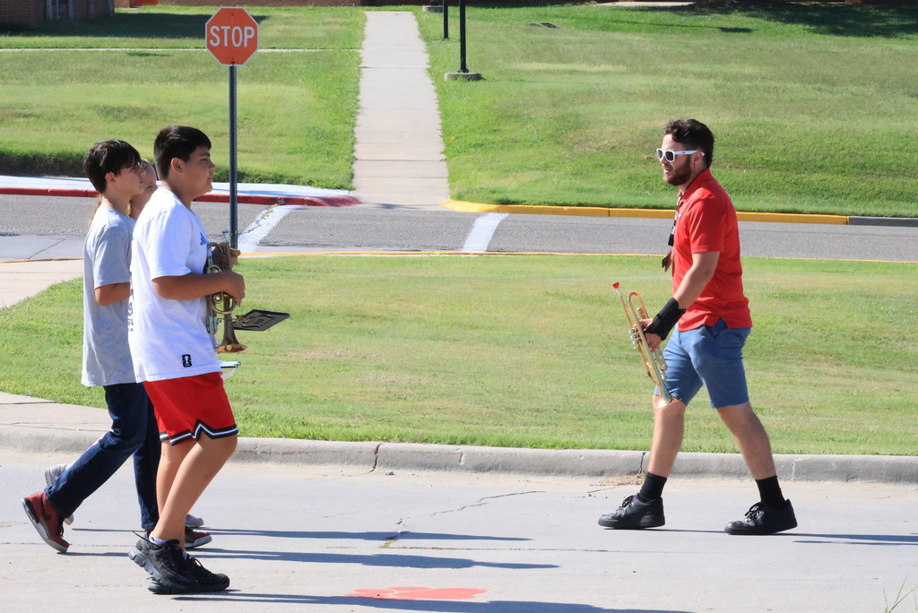 CCCMS 8th graders practice marching and twirling in the parking lot.