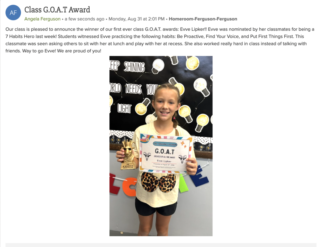 Evve Lipker smiles while holding a trophy and certificate recognizing her as Mrs. Ferguson’s first Class G.O.A.T. Award winner for demonstrating positive habits, including kindness, inclusion, and hard work.