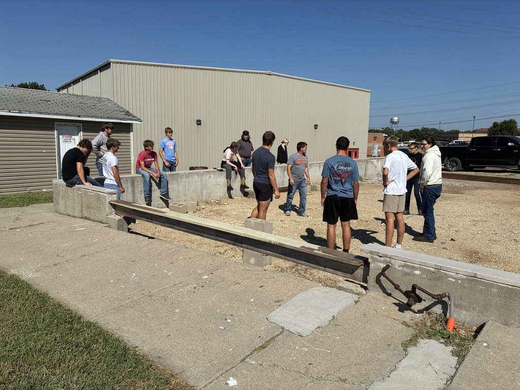 Mr. Pfizenmaier's construction technology class looks over the foundation of the Tiger House.