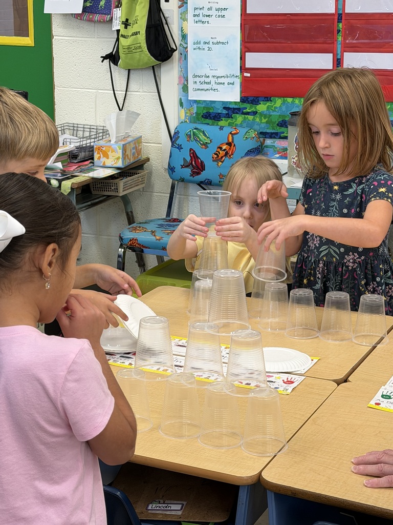 Mrs. Judy's K-1 class work on their leadership and teamwork skills by stacking cups in small groups.