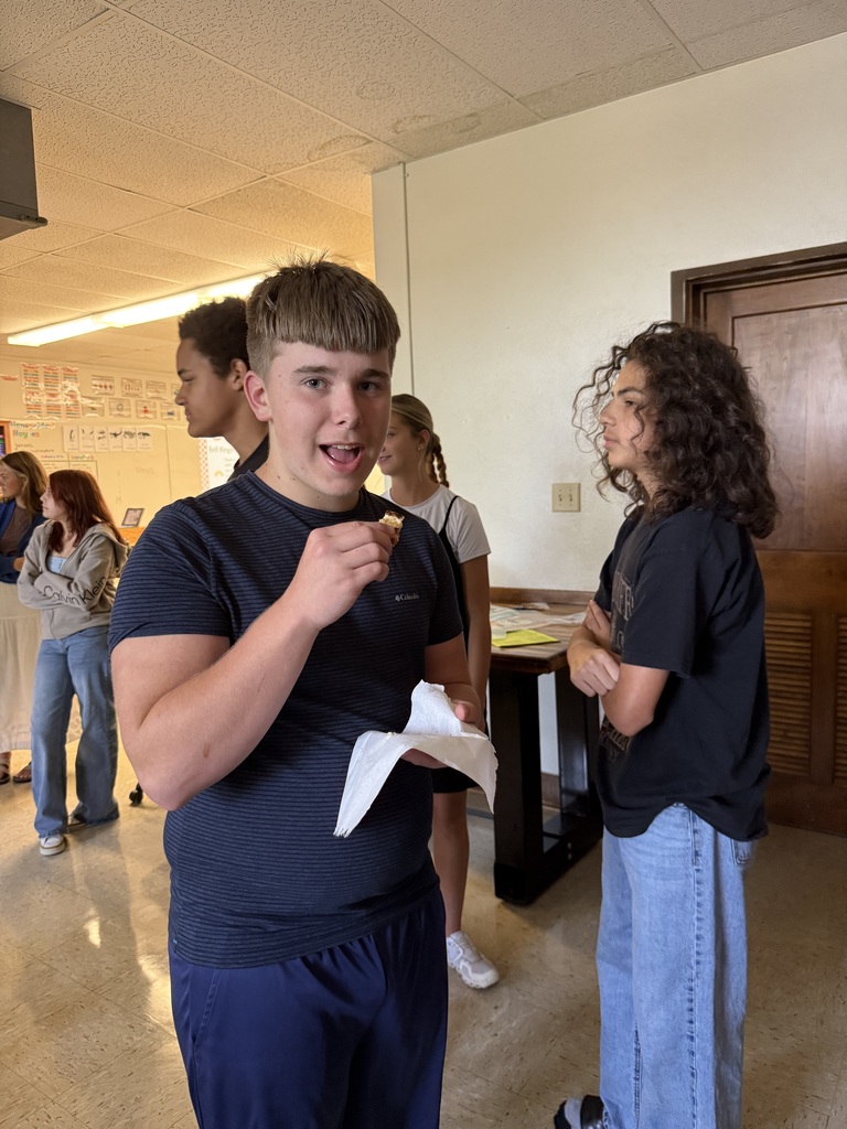 Students eat grilled cheese sandwiches that were prepared by Mrs. Hughes using directions written by her students.