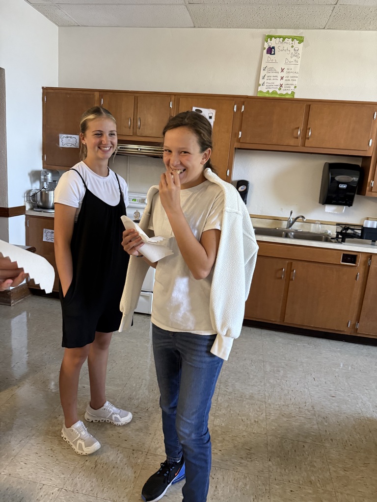 Students eat grilled cheese sandwiches that were prepared by Mrs. Hughes using directions written by her students.
