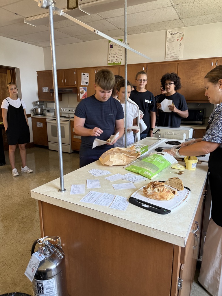 Students eat grilled cheese sandwiches that were prepared by Mrs. Hughes using directions written by her students.