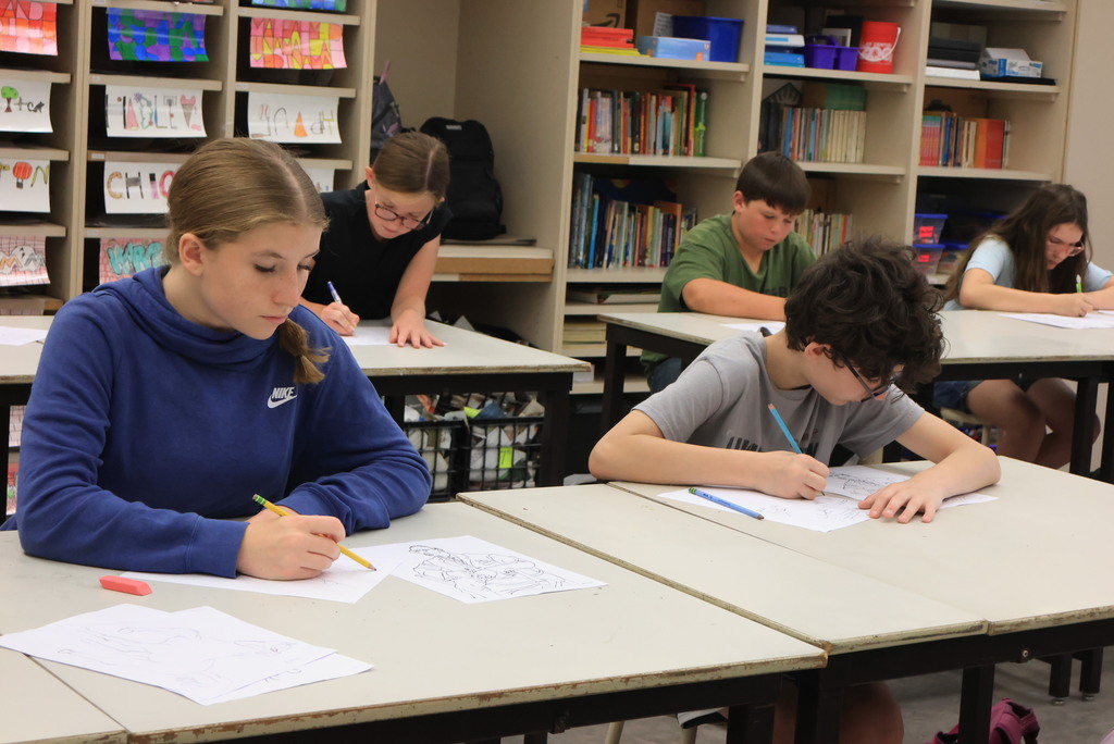 Mrs. Argo's 7th grade art class worked on contour line drawing by recreating a human drawing, only upside down. The goal is to learn to recreate lines rather than the image itself. 