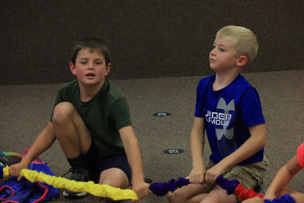 Mrs. Rourke has her students practice rowing a boat, then they grabbed a circular "rope" and rowed together to learn rhythm and move to the beat! 