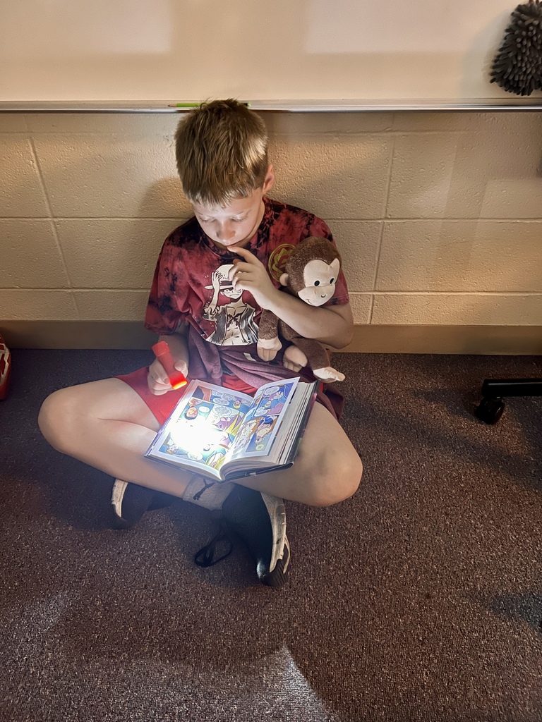Mrs. Knepper's class reads in the dark as part of "Flashlight Friday".