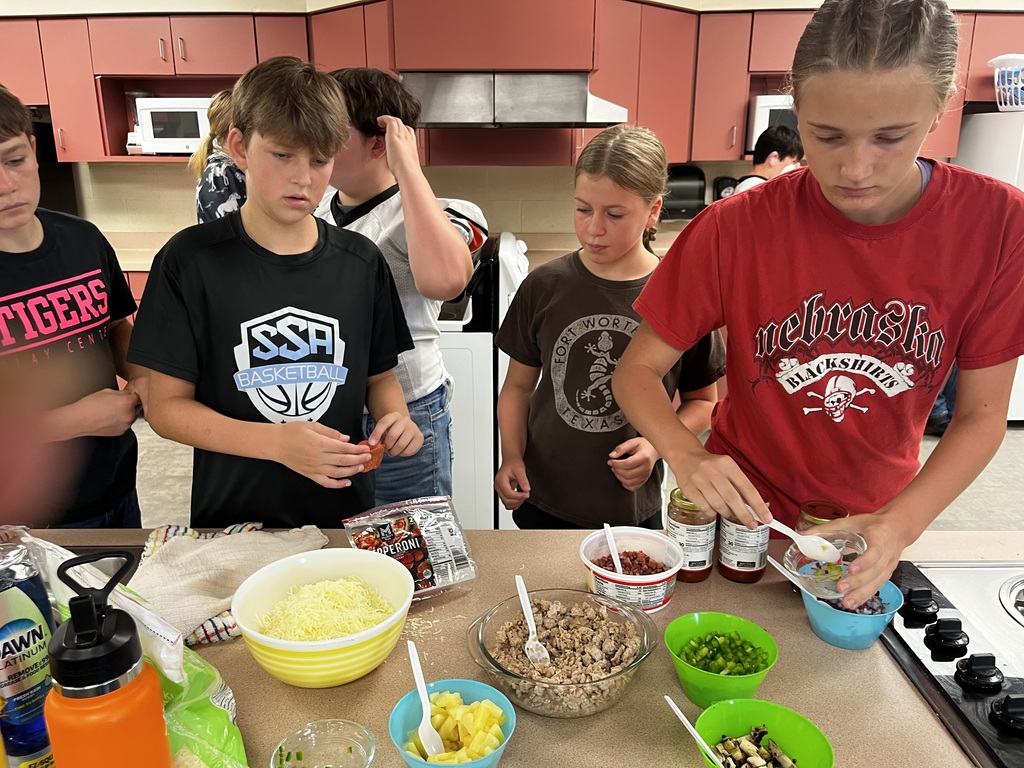 Mini pizzas are a favorite during Mrs. McDonald's Kitchen Safety and Sanitation Unit. They made the pizzas and cleaned up afterward.