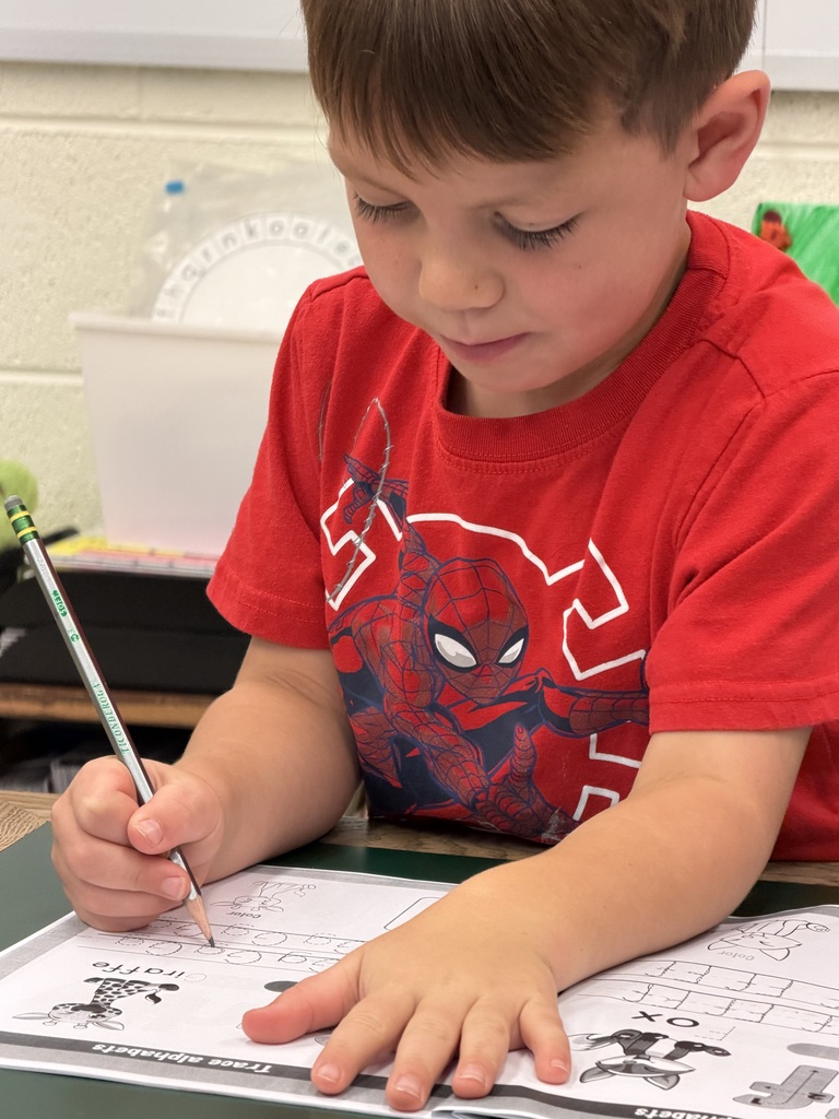 Mrs. Judy's K-1 class diligently works on correct letter formation in their handwriting.