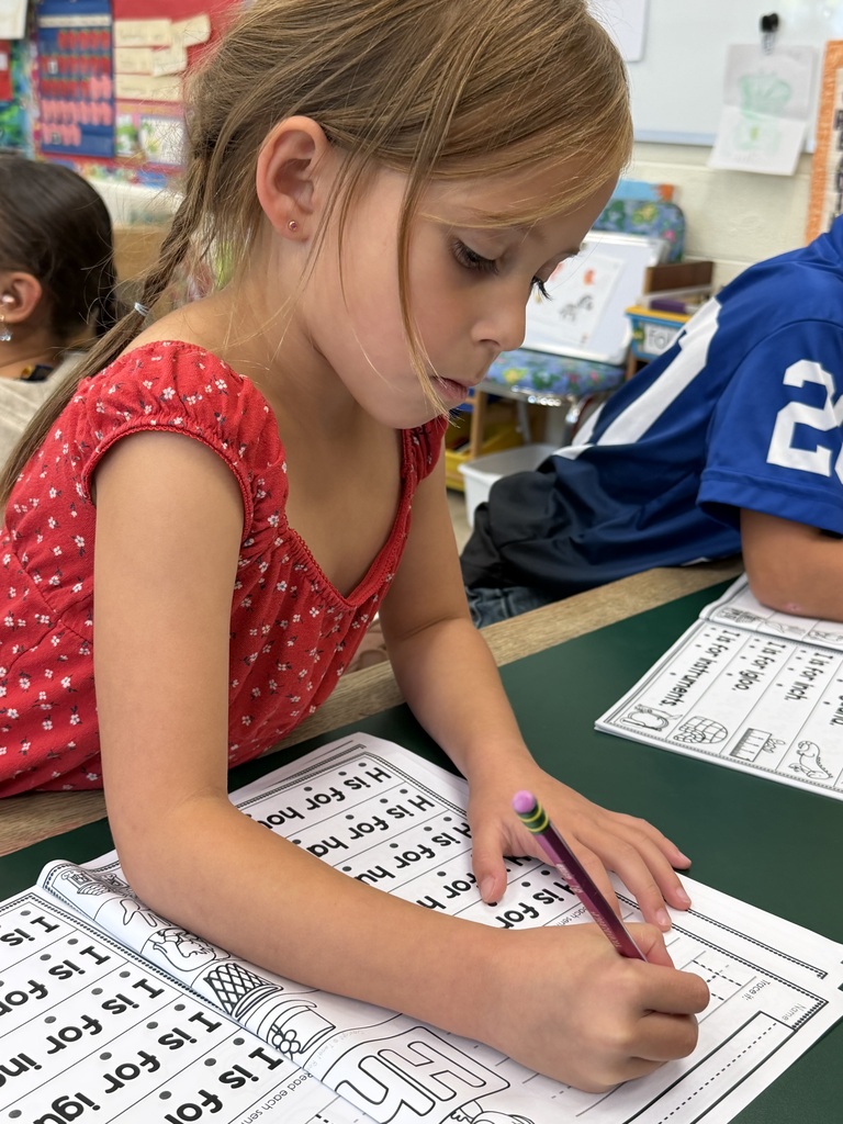Mrs. Judy's K-1 class diligently works on correct letter formation in their handwriting.