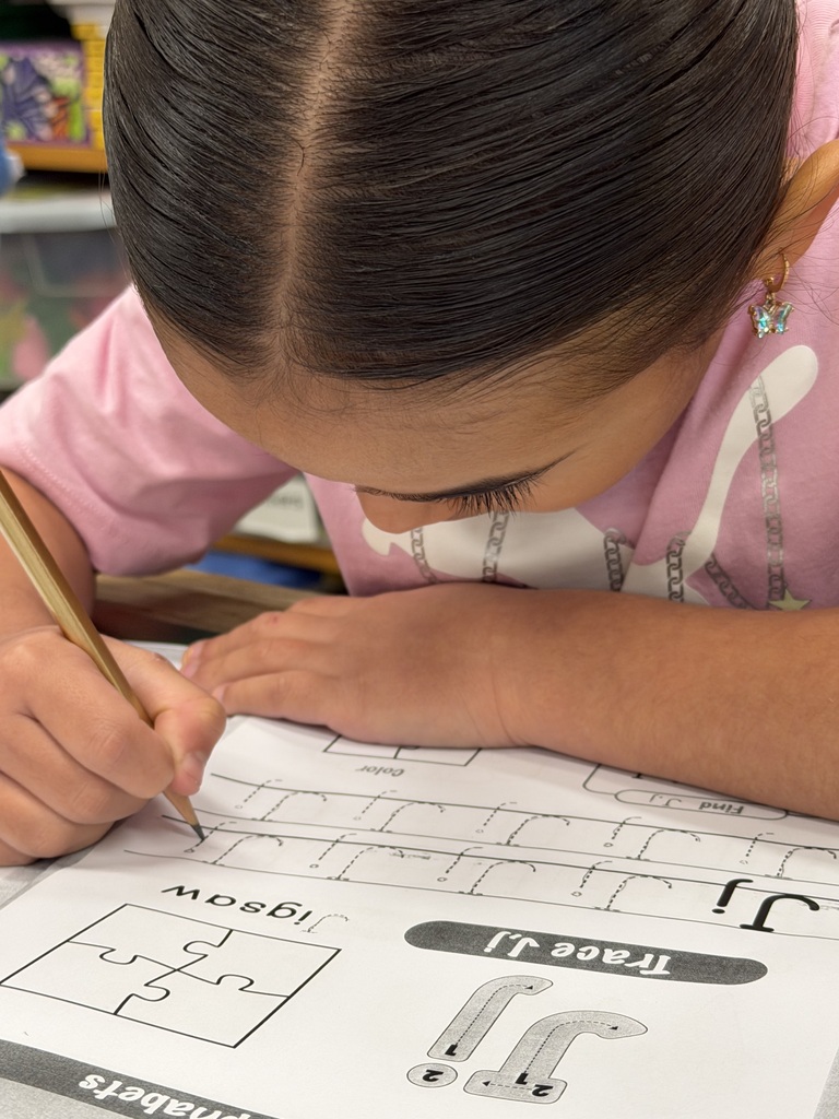 Mrs. Judy's K-1 class diligently works on correct letter formation in their handwriting.