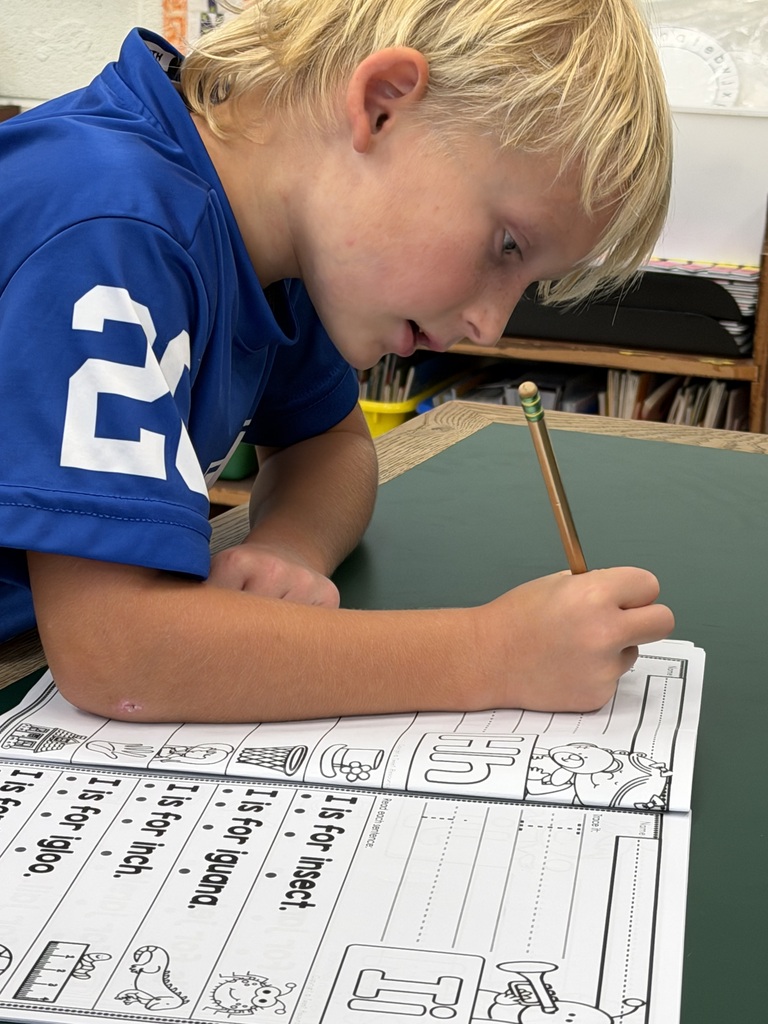 Mrs. Judy's K-1 class diligently works on correct letter formation in their handwriting.