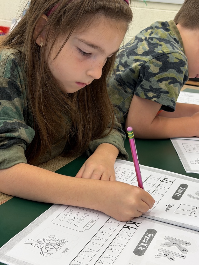 Mrs. Judy's K-1 class diligently works on correct letter formation in their handwriting.