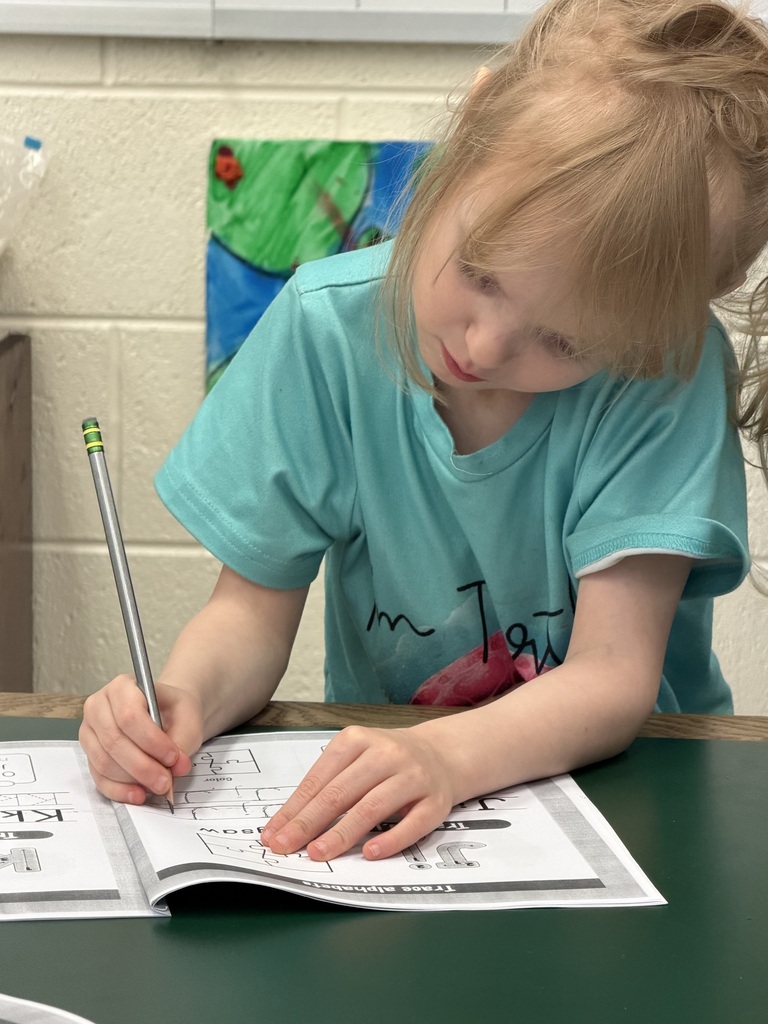 Mrs. Judy's K-1 class diligently works on correct letter formation in their handwriting.