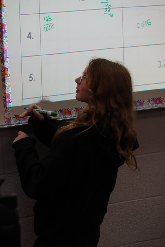 Mrs. Bybee's 7th grade math class was working hard on converting fractions, decimals, and percents today. Individual students came up to the board to solve their problems for the rest of the class.
