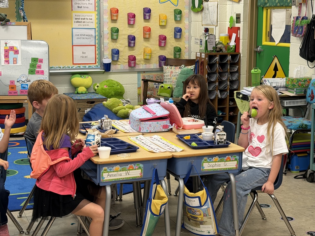 Mrs. Judy's kindergarten/first grade combo class eats lunch as Mrs.Orr, the Librarian at the Wakefield Public Library, and her Assistant, Mrs.Weir, reads to them.