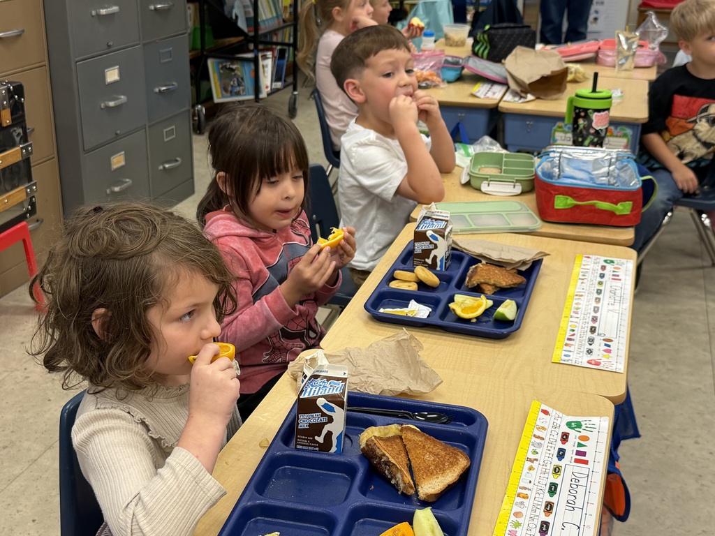 Mrs. Judy's kindergarten/first grade combo class eats lunch as Mrs.Orr, the Librarian at the Wakefield Public Library, and her Assistant, Mrs.Weir, reads to them.