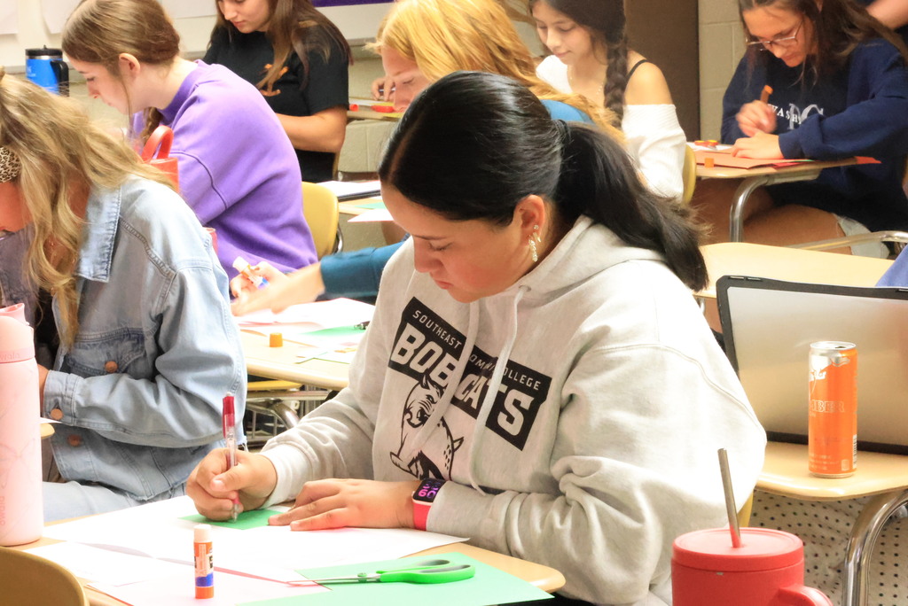 Mrs. Brenneman's first-year journalism students are going old-school with their initial yearbook designs, using paper and glue to create pages they will build later in the year.