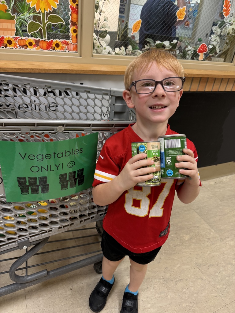 Mrs. Shannon's class helps stock grocery carts for the "V is for Vegetables" food drive. All items will go to the Lighthouse.