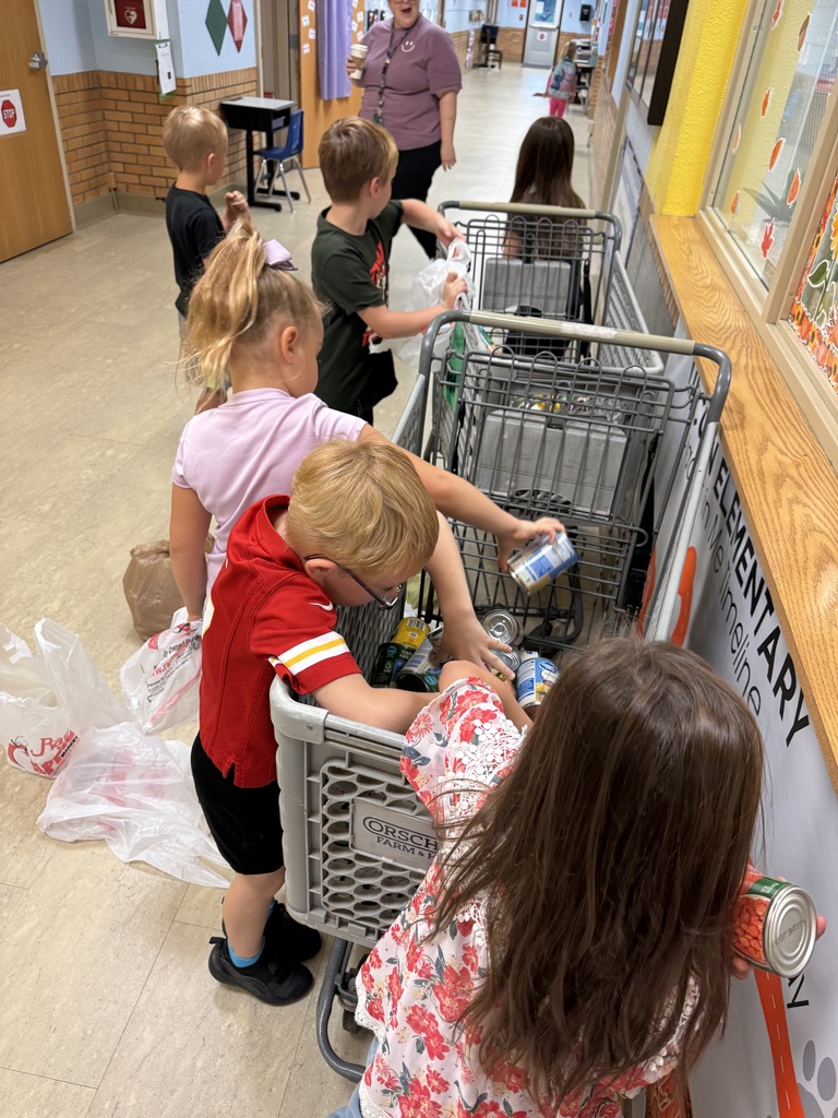 Mrs. Shannon's class helps stock grocery carts for the "V is for Vegetables" food drive. All items will go to the Lighthouse.