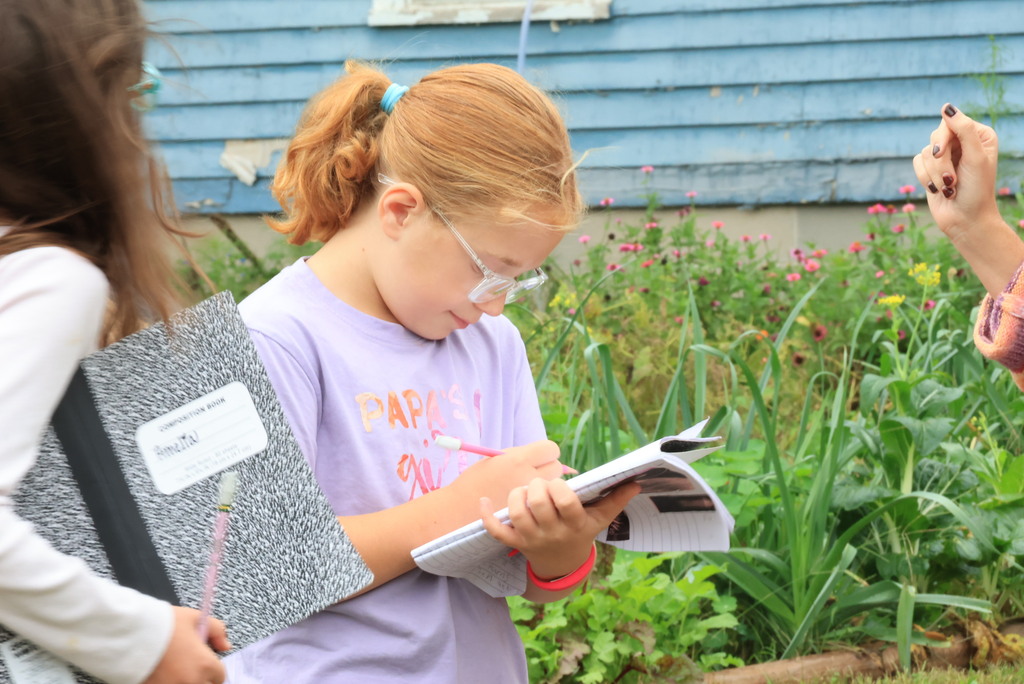 Mrs. Wietharn's 3rd graders document in their science notebooks while on a nature walk around the community.